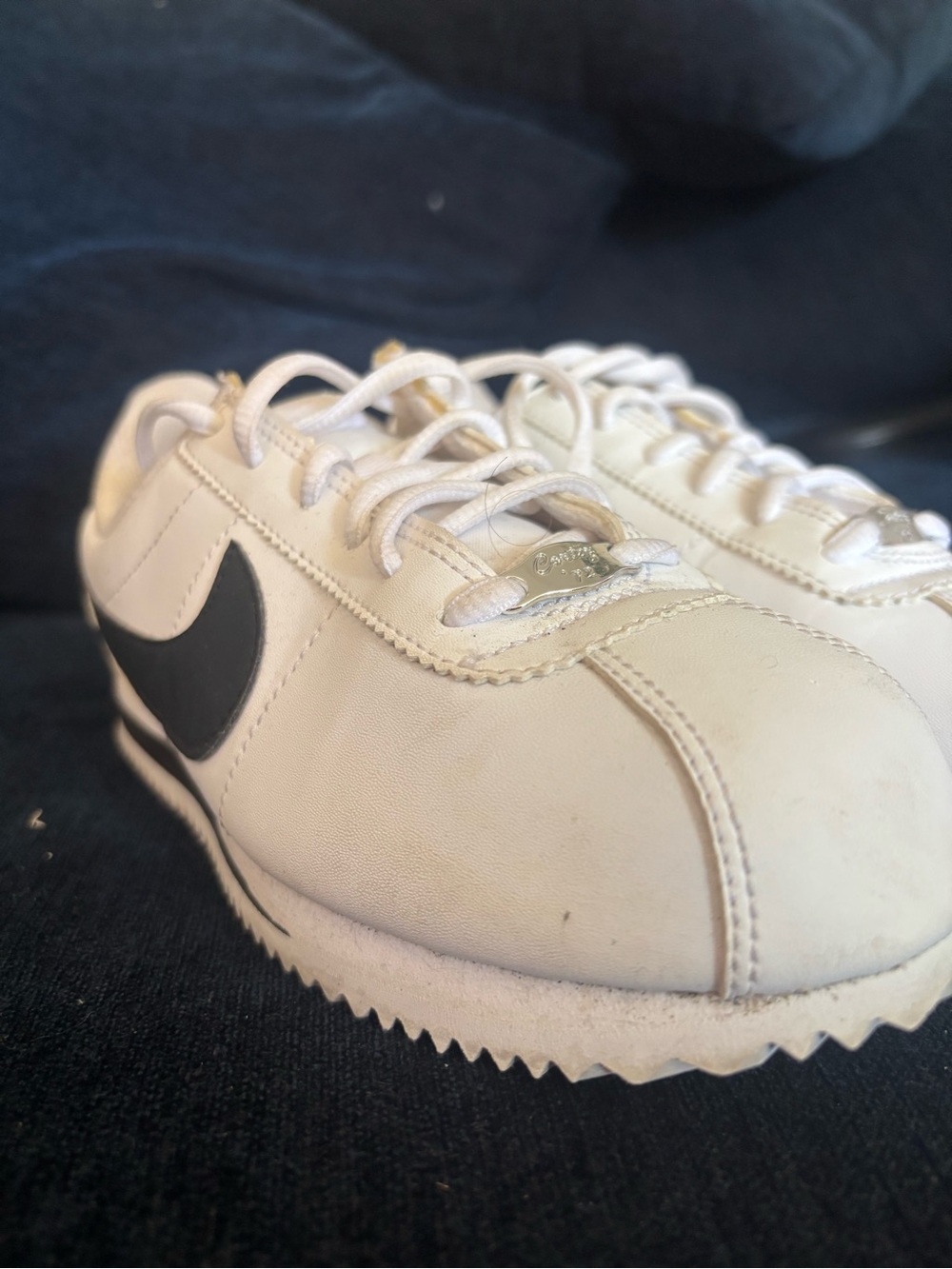 Nike Men’s White Leather Sneakers with Black Swoosh